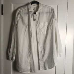 White button up, long sleeve top.